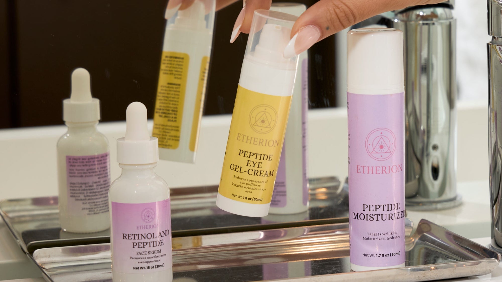 Hand holding a bottle of Efferacur skincare product on a tray with other skincare items.